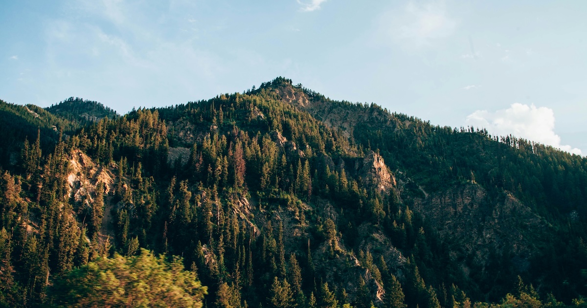 Green mountain under blue sky